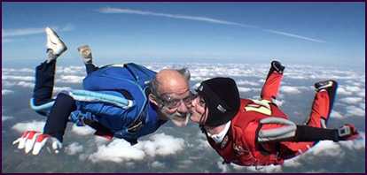 Sigurd Olivier, Dutch marionette player, on his 335th jump, receives congratulatory kisses from Christien Meijers on his 70th birthday.